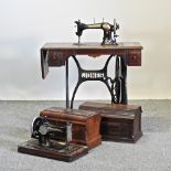 An early 20th century sewing machine on table, 86cm, together with another sewing machine,