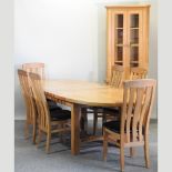 A modern light oak extending dining table, with two additional leaves, 270 x 110cm overall,