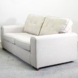 A modern cream upholstered sofa,