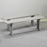 A pair of grey painted benches,