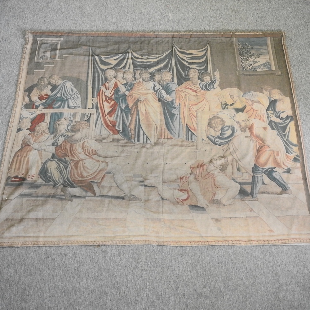 A tapestry style wall panel, printed with a medieval scene, on a wooden pole,