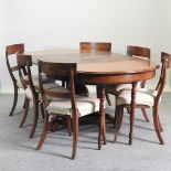 An early 19th century mahogany extending dining table, with two additional leaves,