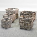 Two sets of three wicker log baskets,