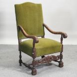 A late 19th century carved oak and green upholstered throne chair