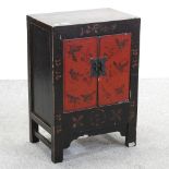 An oriental ebonised side cabinet, decorated with butterflies,