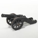 A painted cast iron signal cannon, on a metal carriage,