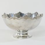 A modern silver bowl, of circular shape, with an undulating rim, on a pedestal base,