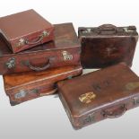 A collection of five early 20th century vintage leather cases,