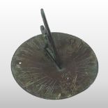 An antique bronze sun dial, dated 1687 and inscribed with a verse, 'Serene I Stand,
