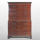 A George III mahogany chest on chest, fitted with a brushing slide, on bracket feet,