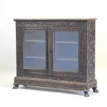 A 19th century Anglo-Indian carved rosewood dwarf glazed bookcase,