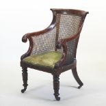 A late Regency carved mahogany single cane bergere armchair,