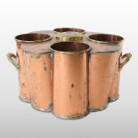A 19th century copper and brass wine cooler, of twin handled cluster form, to hold four bottles,