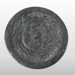 A Chinese bronze mirror, of circular shape, decorated in relief with fish,
