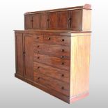 A 19th century mahogany estate cabinet, the superstructure enclosed by three pairs of sliding doors,
