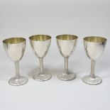 A set of four modern silver wine goblets, each having a textured stem, London 1977, 602g gross,