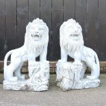 A pair of Chinese carved grey marble garden statues of temple dogs, each on a plinth base,