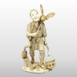 A late 19th century Japanese carved ivory figure of a wood gatherer, Meiji period, shown standing,