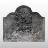 A large cast iron fire back, relief decorated with horse before a tree,