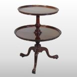 A George III style mahogany two tier dumb waiter, having two dished graduated tiers,