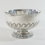 An Edwardian silver bowl, of circular shape, with a half gadrooned body, on a pedestal foot,