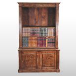 A dark oak metamorphic standing bookcase,