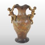 A late 19th century Goldscheider terracotta twin handled vase, decorated with a nude lady swimming,