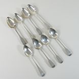 A collection of four Georgian silver fiddle pattern dessert spoons, various dates and makers,
