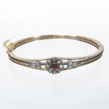 An early 20th century unmarked ladies bangle, of hinged design,