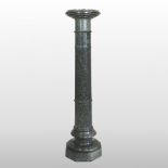 A green turned marble column, in sections, on an octagonal base, 112cm high.