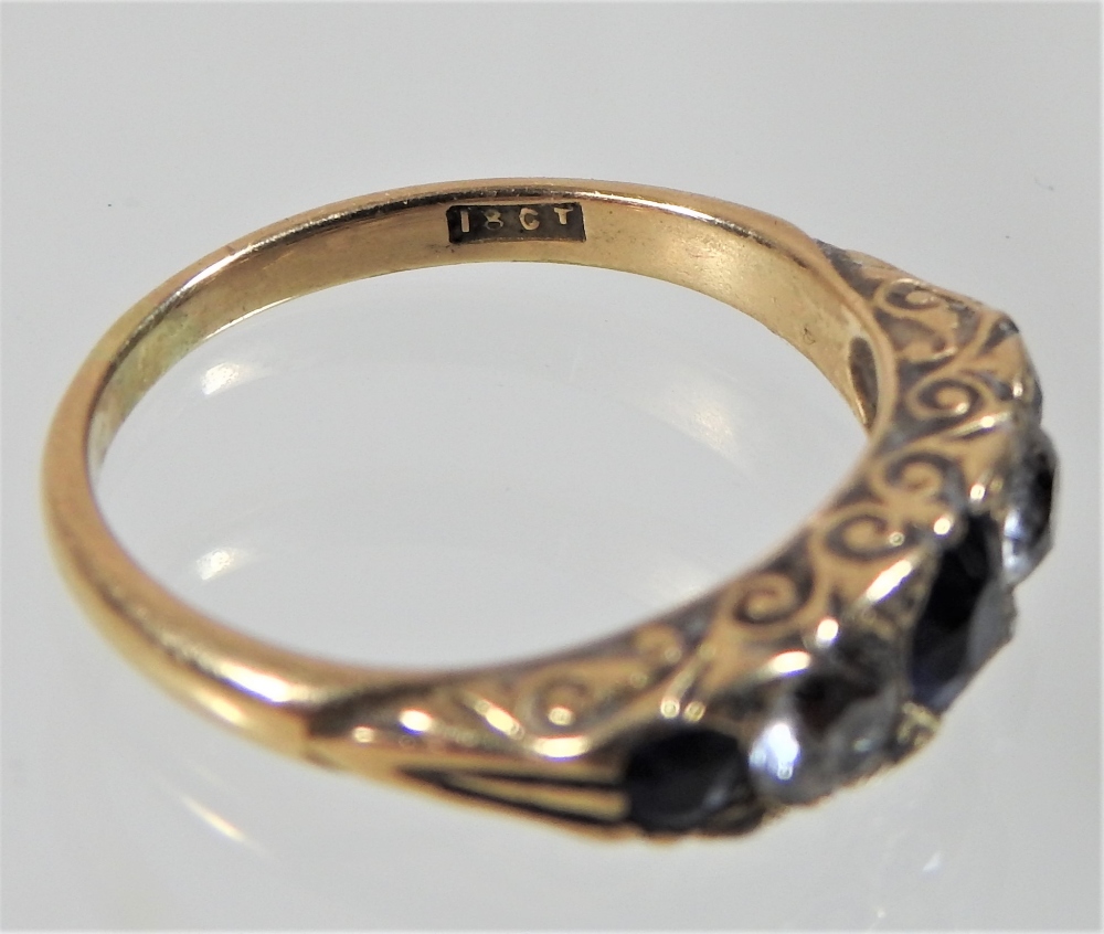 An early 20th century 18 carat gold sapphire and diamond five stone ring, with textured shoulders, - Image 2 of 4