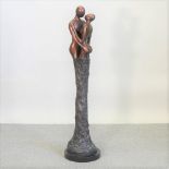 A contemporary figural bronze sculpture, of a couple kissing, on a marble plinth,