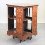 An Arts and Crafts oak and inlaid revolving bookcase, circa 1900, attributed to Shapland & Petter,