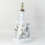 A 19th century Sitzendorf white glazed figural lamp base, in the form of three cherubs,