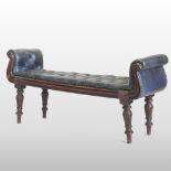 A William IV carved mahogany window seat, with a leather upholstered buttoned seat, on turned legs,
