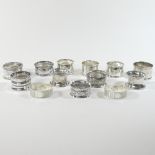 A collection of thirteen Victorian and later silver napkin rings, various designs, dates and makers,