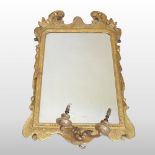 An 18th century carved wood and gilt gesso framed girandole, having a rectangular plate,