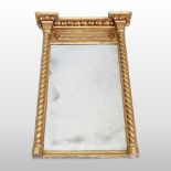 A Regency carved pine and gilt gesso framed wall mirror, the rectangular plate,