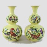 A pair of early 20th century Helena Wolfsohn porcelain gourd vases, each painted with exotic birds,
