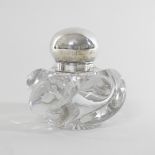 An Edwardian glass inkwell, of wrythen shape, with a hinged silver lid, by Mappin and Webb,
