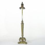 An ornate Biedermeier gilt brass table lamp base, having a twisted fluted column,