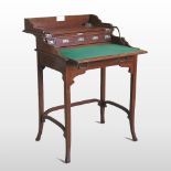 An unusual Edwardian mahogany writing desk, with a hinged top and fitted interior, on square legs,