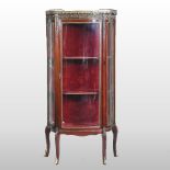 An early 20th century mahogany and gilt metal mounted display cabinet, of serpentine shape,