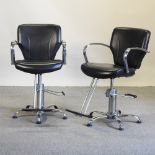 A pair of mid 20th century black upholstered and chrome barbers chairs