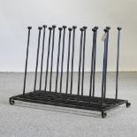 A black painted wrought iron boot rack,