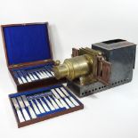 A 19th century magic lantern, together with a 19th century canteen of cutlery,