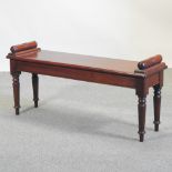 A Regency style mahogany window seat, on turned legs,