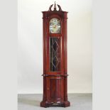 A modern longcase clock, with a swan neck pediment and glazed door,