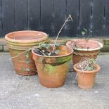 A collection of four terracotta planters,
