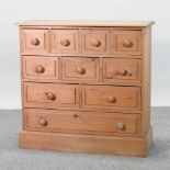 A pine chest, containing an arrangement of drawers,